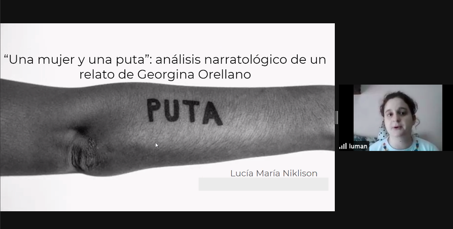 Captura de pantalla de Lucía Niklison presentando. En la diapositiva se ve el brazo de Georgina Orellano con la palabra "puta" tatuada en él.